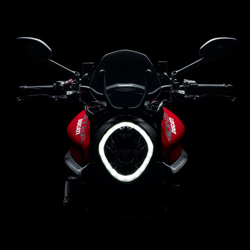 Motorcycle with a prominent headlight on a black background