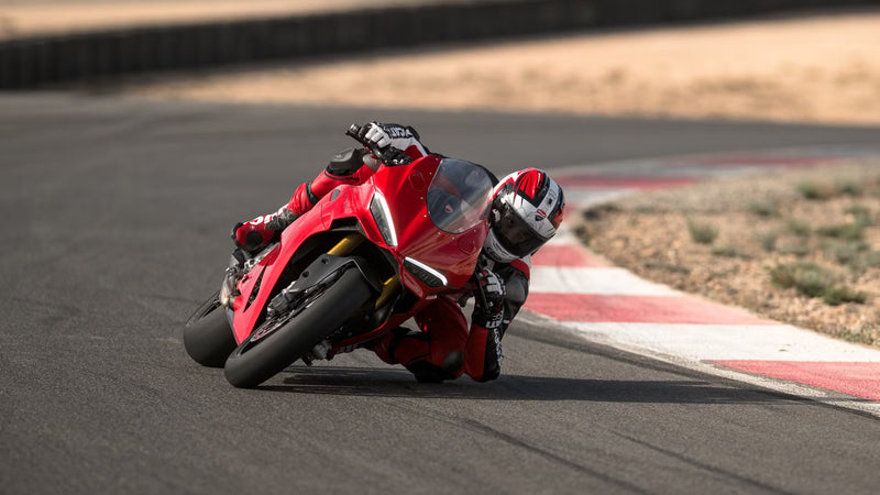 Red Ducati motorcycle on a racetrack with a blurred background