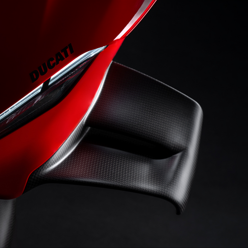 Close-up of a red Ducati motorcycle part on a black background